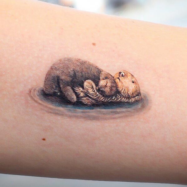 Amelia's otter mum and baby tattoo