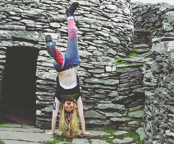 Fleur and her otter tattoo doing a hand stand