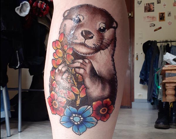 Otter with flowers tattoo