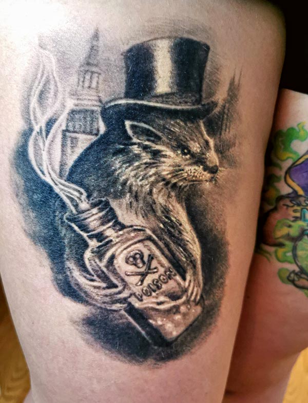 Otter with poison bottle left leg tattoo