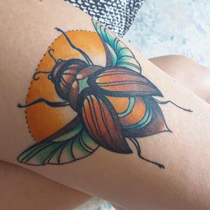 Beetle tattoo on thigh